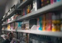 woman in black shirt standing in front of store shelf