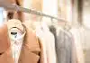 brown coat hanged on white plastic hanger